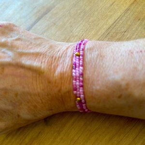 Elastic bead bracelet made by 10yo for school $. Stretchy—pink.